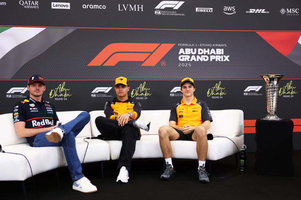 McLaren drivers Lando Norris and Oscar Piastri with Red Bull's Max Verstappen during the pre-event press conference at the 2025 F1 Abu Dhabi Grand Prix