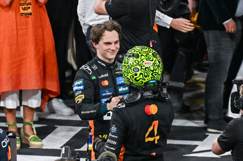 Oscar Piastri congratulating Lando Norris for winning the 2025 Formula 1 drivers' championship at the Abu Dhabi Grand Prix