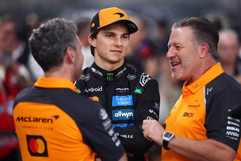 McLaren driver Oscar Piastri speaking to Zak Brown and Andrea Stella at the 2025 Formula 1 Abu Dhabi Grand Prix