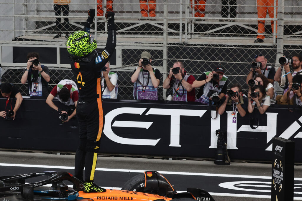 McLaren driver Lando Norris standing on his car celebrating finishing third at the 2025 Formula 1 Abu Dhabi Grand Prix
