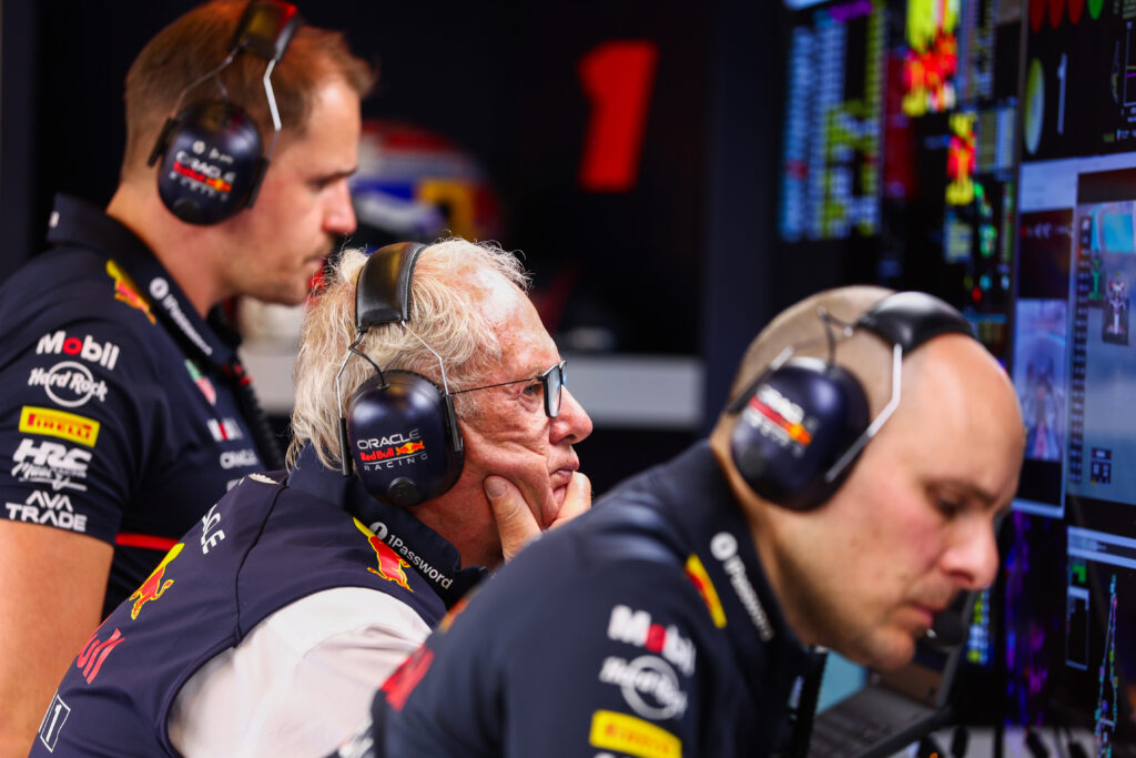 former Red Bull motorsport adviser Helmut Marko looks at data in the garage with Max Verstappen's race engineer Gianpiero Lambiase during practice at the 2025 F1 Abu Dhabi Grand Prix