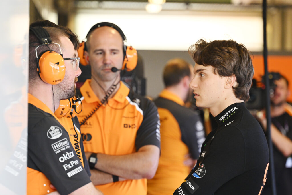 Oscar Piastri speaking to McLaren staff in the garage at the 2025 Formula 1 Abu Dhabi Grand Prix