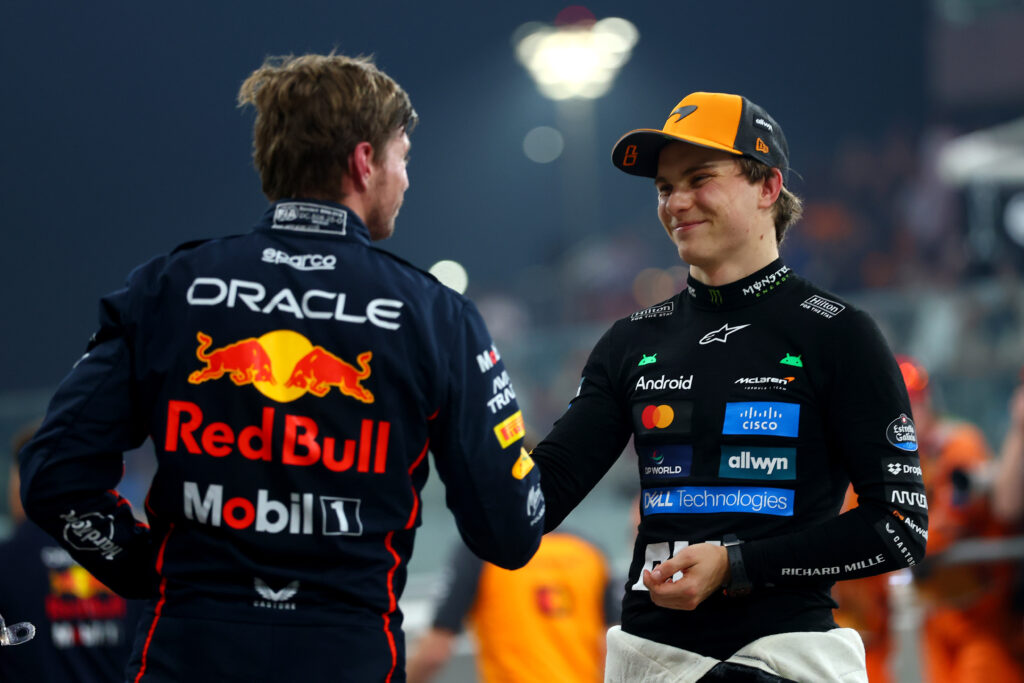 Max Verstappen and Oscar Piastri shaking hands at the 2025 Formula 1 Abu Dhabi Grand Prix