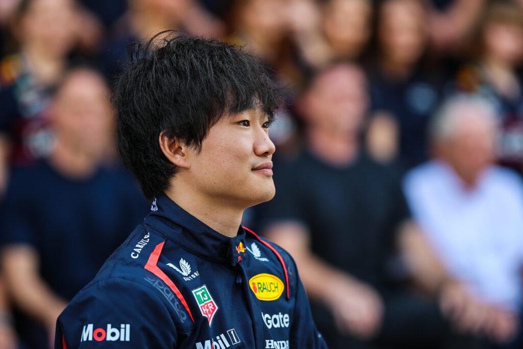 Red Bull driver Yuki Tsunoda sitting on his car at the 2025 Formula 1 Abu Dhabi Grand Prix
