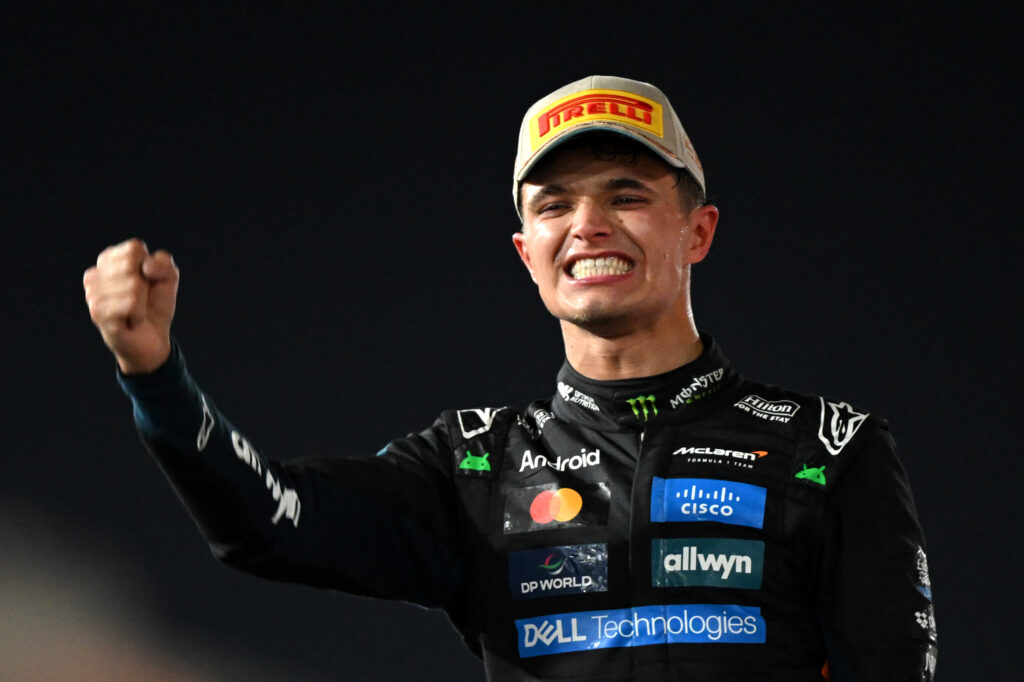 McLaren driver Lando Norris celebrating on the podium at the 2025 Formula 1 Abu Dhabi Grand Prix