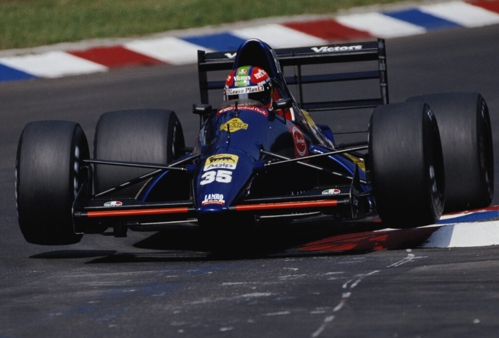 Eric van de Poele racing for Modena at the 1991 German Grand Prix