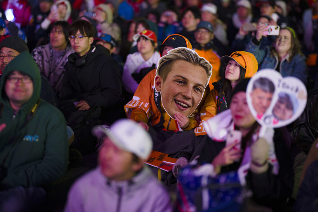 A fan holding a Liam Lawson mask at the 2025 Formula 1 Japanese Grand Prix