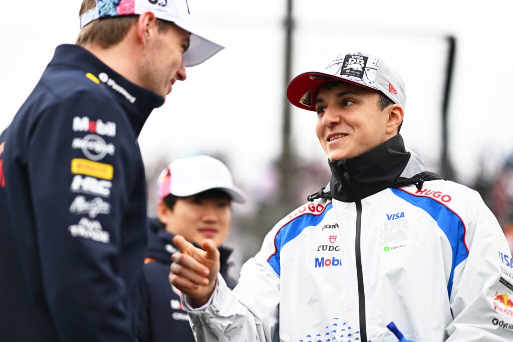 Red Bull driver Max Verstappen speaking to Racing Bulls driver Isack Hadjar at the 2025 Formula 1 Japanese Grand Prix