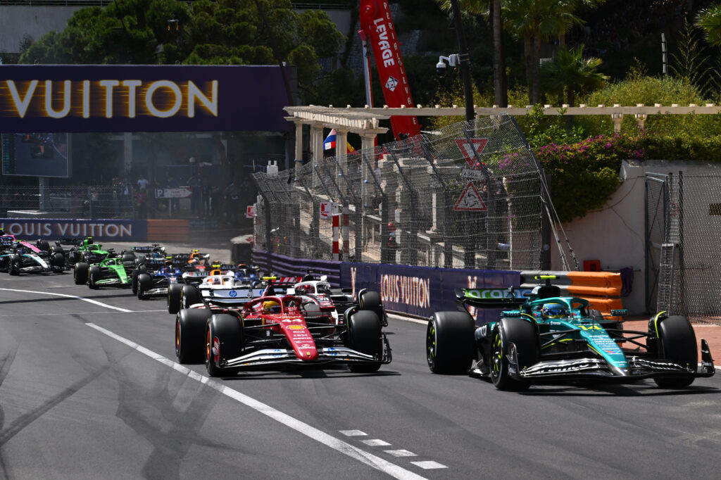 Fernando Alonso and Lewis Hamilton racing up the hill at the 2025 Formula 1 Monaco Grand Prix