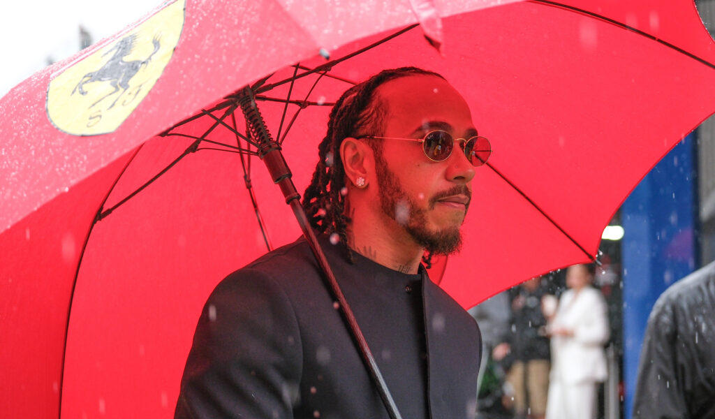 Lewis Hamilton holding a Ferrari umbrella at the 2025 Formula 1 British Grand Prix