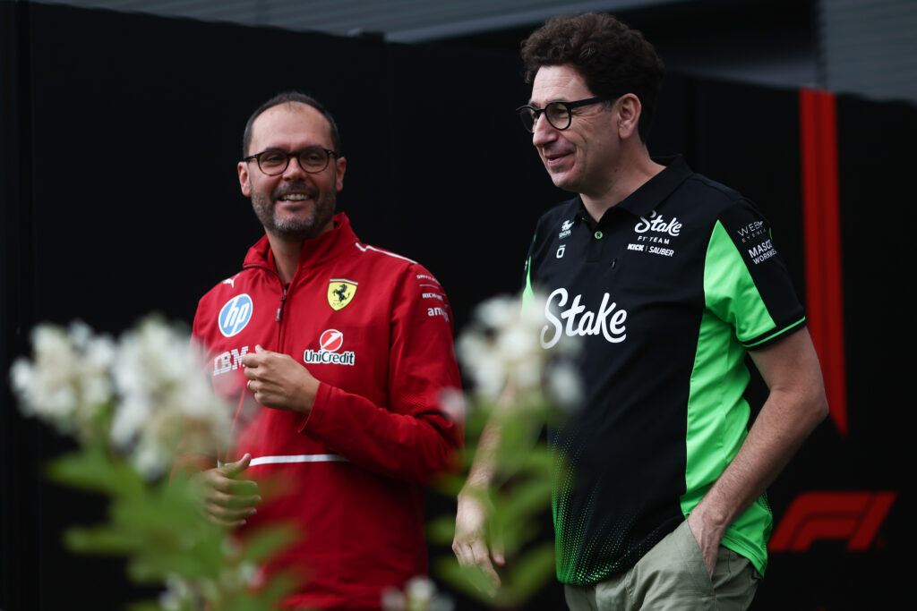 Audi boss Mattia Binotto speaking to a Ferrari staff member of the 2025 Formula 1 Hungarian Grand Prix