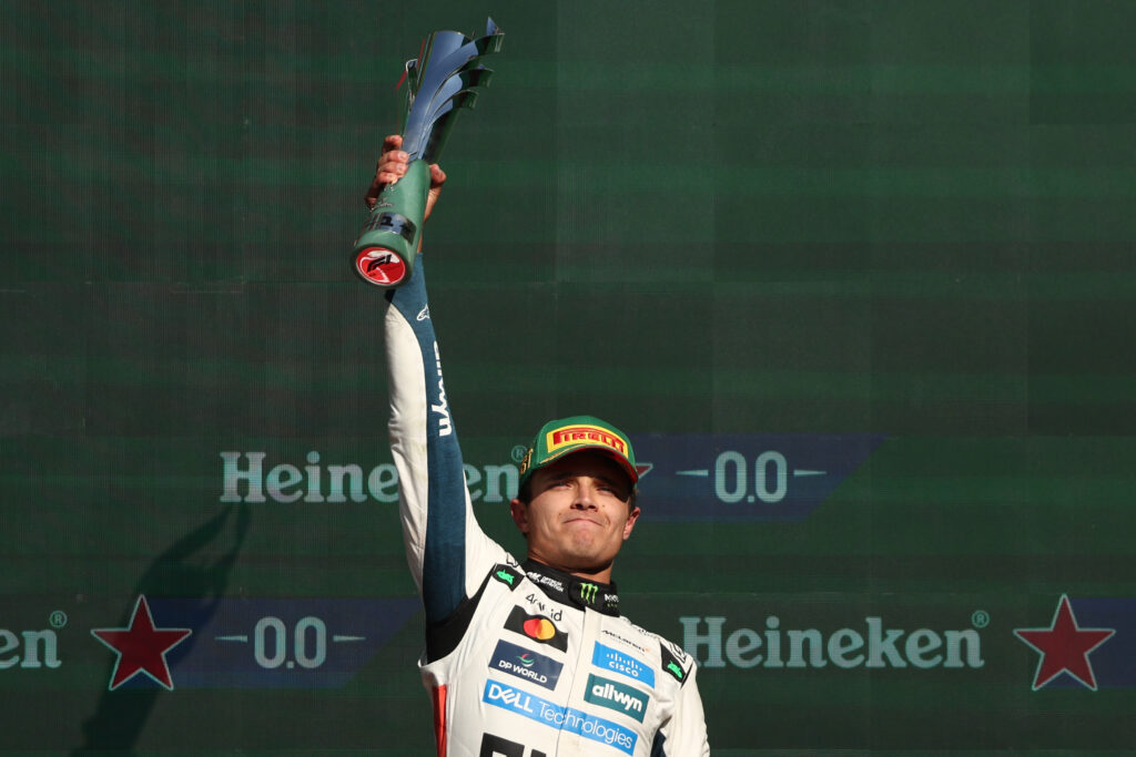 McLaren driver Lando Norris lifting the winner's trophy at the 2025 Formula 1 Mexico City Grand Prix