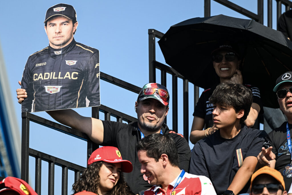A fan holding up a cutout of Sergio Perez in a Cadillac racesuit at the 2025 Formula 1 Mexico City Grand Prix