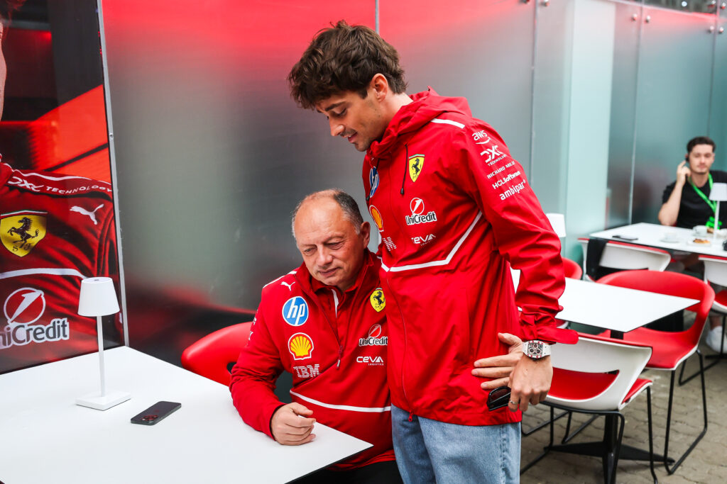 Ferrari driver Charles Leclerc speaks with team principal Fred Vasseur in the paddock ahead of the 2025 F1 Sap Paulo Grand Prix