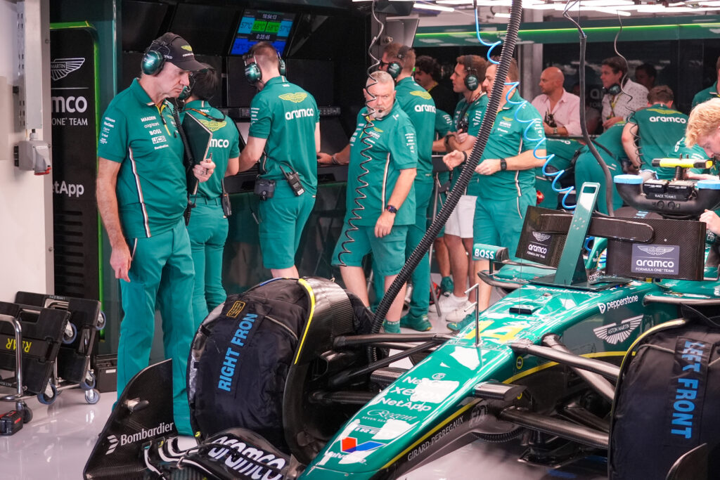 Aston Martin team principal Adrian Newey inspecting a car at the 2025 Formula 1 Qatar Grand Prix
