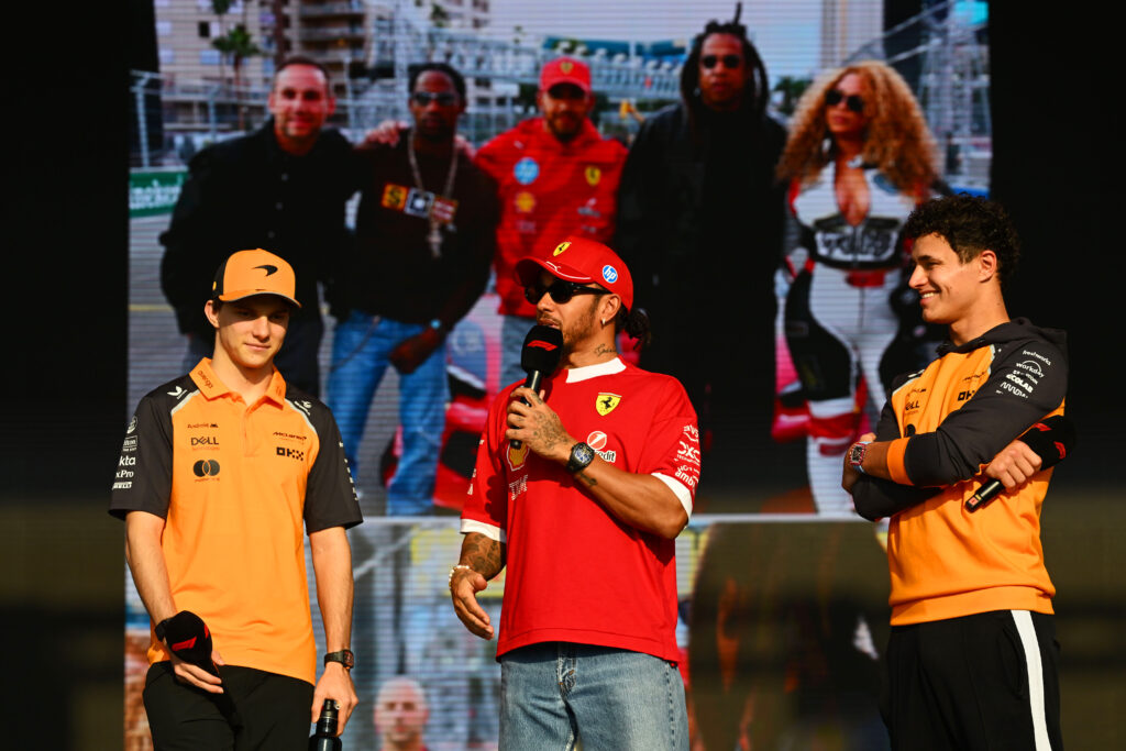 Oscar Piastri, Lewis Hamilton and Lando Norris on a stage at the 2025 Formula 1 Qatar Grand Prix