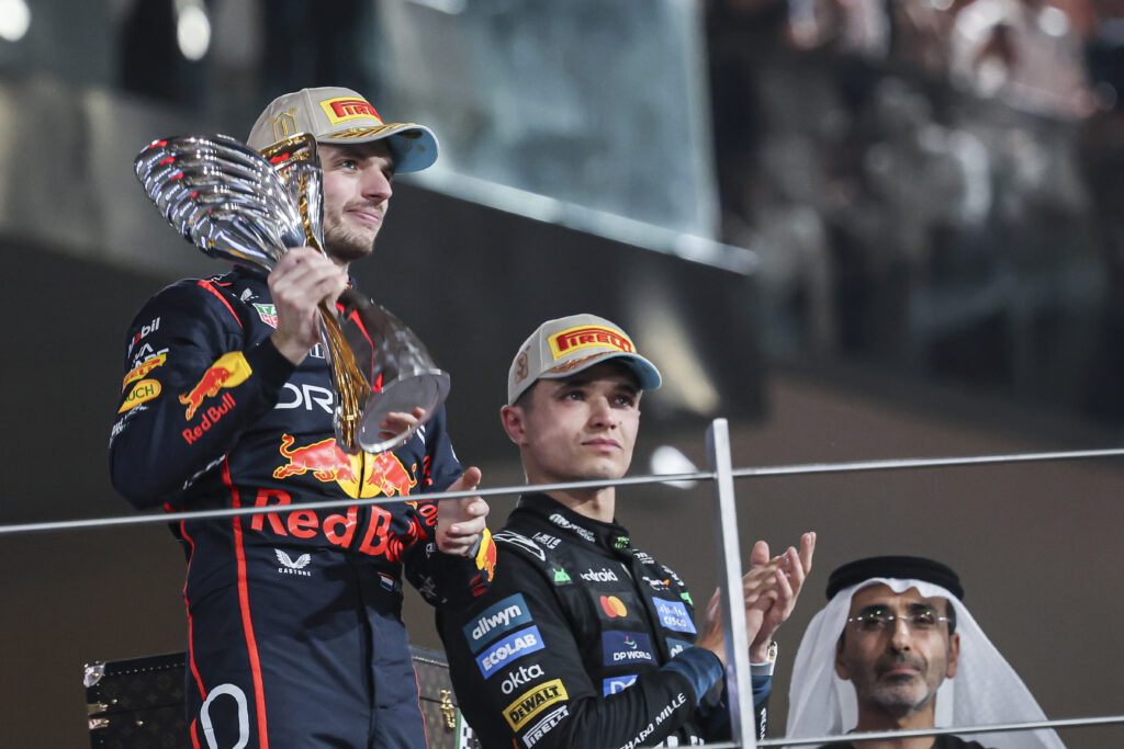 Red Bull driver Max Verstappen holding his trophy on the podium at the 2025 Formula 1 Abu Dhabi Grand Prix