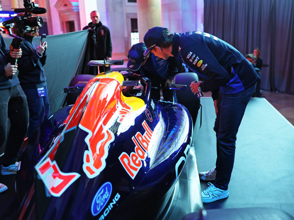 Max Verstappen studying the inside of the 2026 Red Bull F1 car at a launch event in Detroit