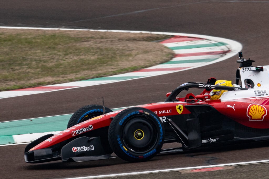 Lewis Hamilton waves to fans as he drives the Ferrari SF-26 at Fiorano