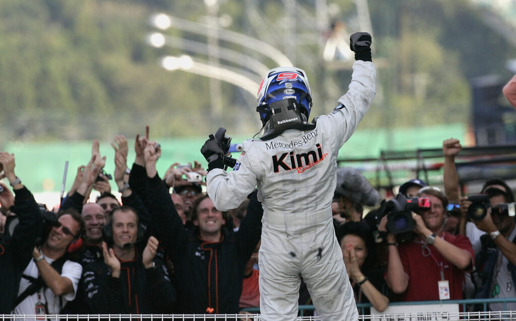 Kimi Raikkonen of McLaren celebrating his win at the 2005 Japanese Grand Prix in front of his engineers and reporters.