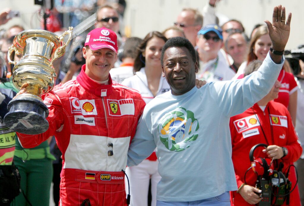 Michael Schumacher receiving a lifetime achievement award from Pele at the 2006 Formula 1 Brazilian Grand Prix