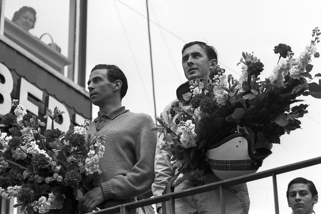 Jim Clark and Jackie Stewart on the podium at the 1965 Belgian Grand Prix