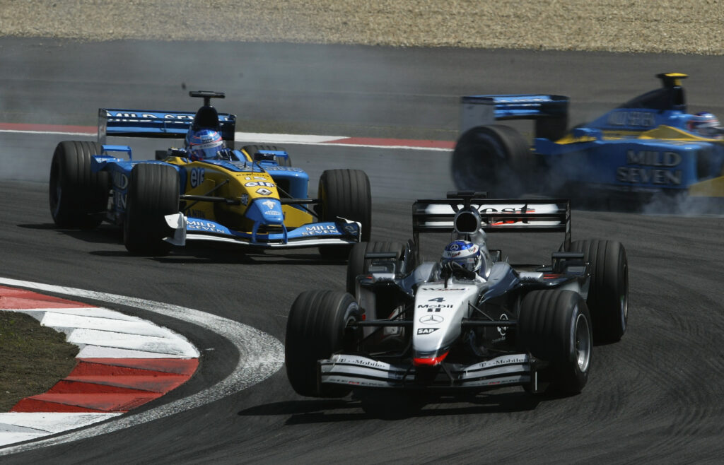 McLaren driver Kimi Raikkonen on track with Renault's Jenson Button during the 2002 European Grand Prix at the Nurburgring