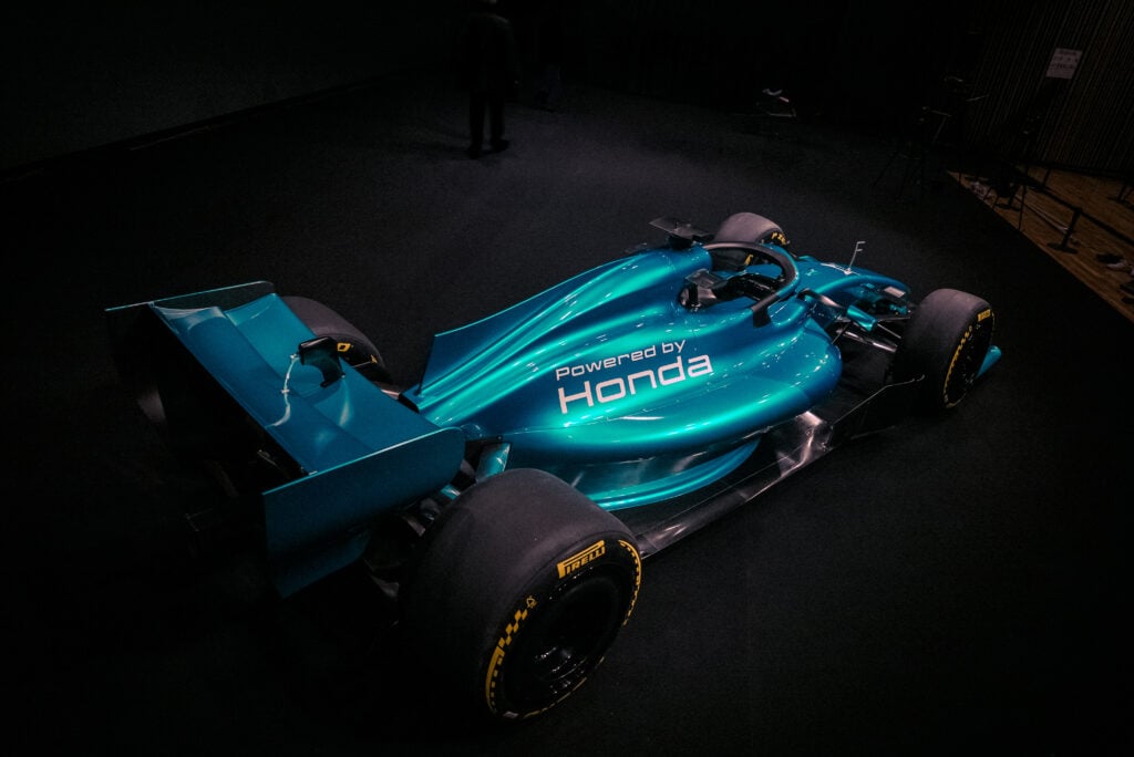 A concept Aston Martin 2026 F1 car with a green livery and Honda's logo on the back