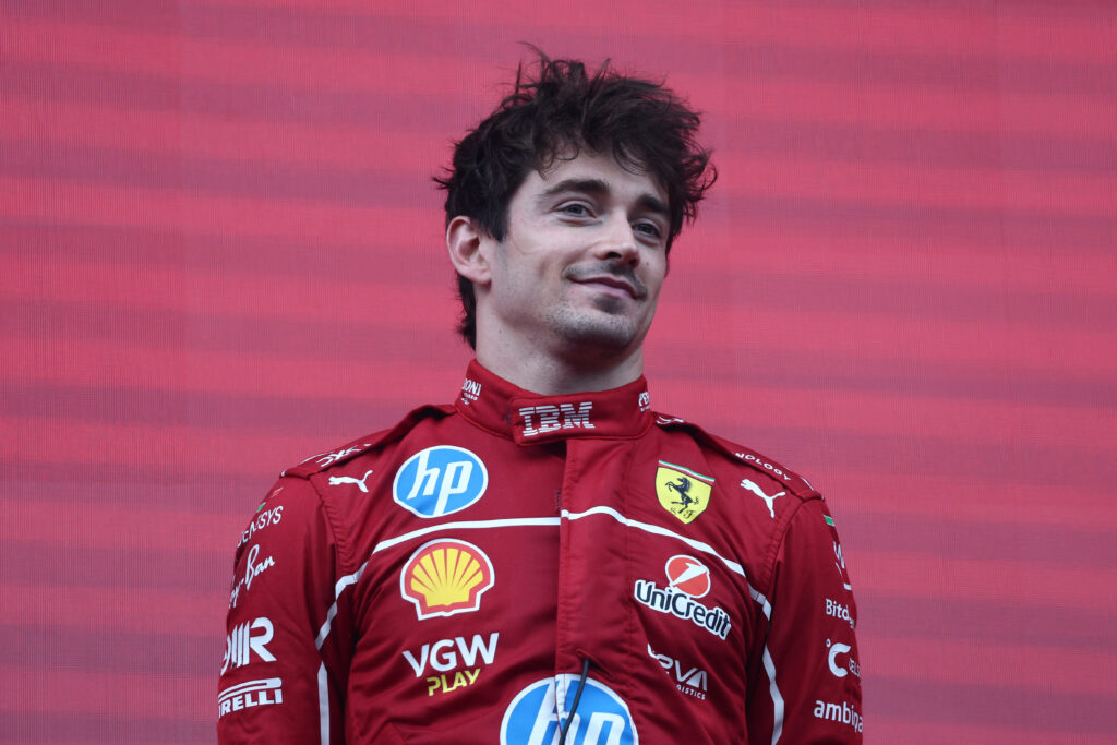Ferrari driver Charles Leclerc standing on the podium at the 2025 Formula 1 Belgian Grand Prix