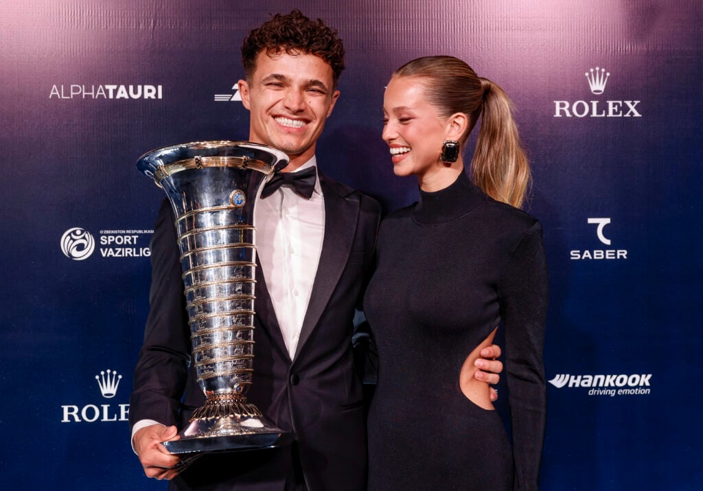 Lando Norris stands with his girlfriend, Margarida Corceiro, whilst holding the Formula 1 championship trophy at the 2025 FIA awards
