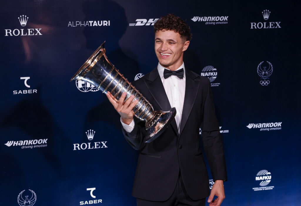 McLaren driver Lando Norris poses with the 2025 F1 drivers' championship trophy at the FIA gala