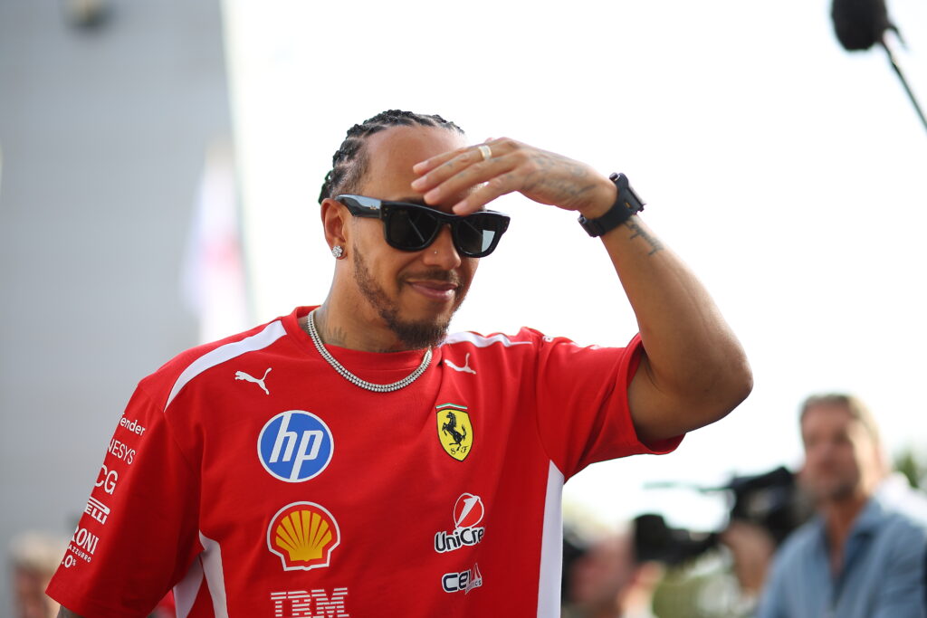 Lewis Hamilton of Ferrari walks in the Bahrain F1 testing paddock