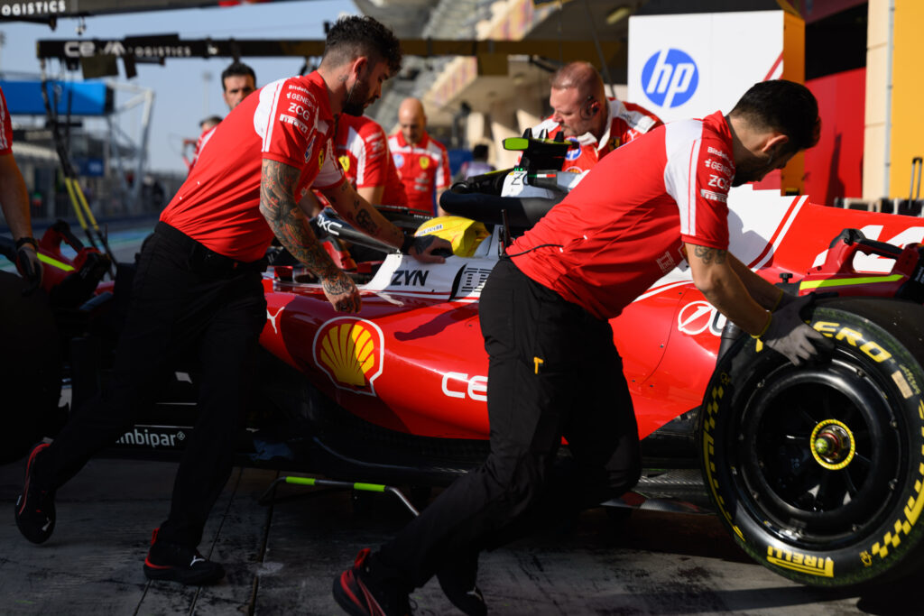 Ferrari mechanics push Lewis Hamilton back into the garage during the first 2026 F1 Bahrain pre-season test