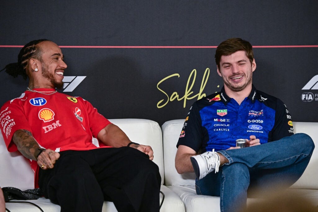 Lewis Hamilton and Max Verstappen laughing during a press conference at 2026 Bahrain pre-season testing