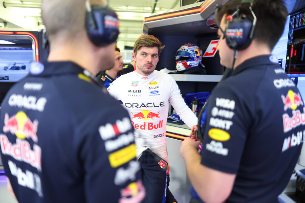 Red Bull driver Max Verstappen speaks to race engineer Gianpiero Lambiase in the garage during the 2026 F1 Bahrain pre-season test