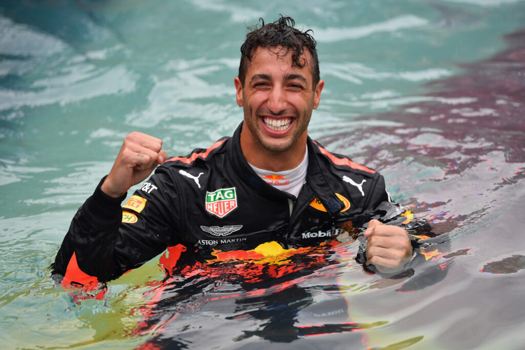 Daniel Ricciardo celebrating his win at the 2018 Monaco Grand Prix in the famous swimming pool.