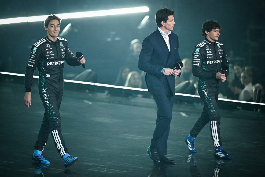 (From L) Mercedes' British driver George Russell, Mercedes' Austrian team principal Toto Wolff, Mercedes' Italian driver Andrea Kimi Antonelli arrive on stage to present the new Formula 1 car of Mercedes Formula One Team during the Formula One - 2025 season launch "F1 75 LIVE" event at the O2, in London, on February 18, 2025.