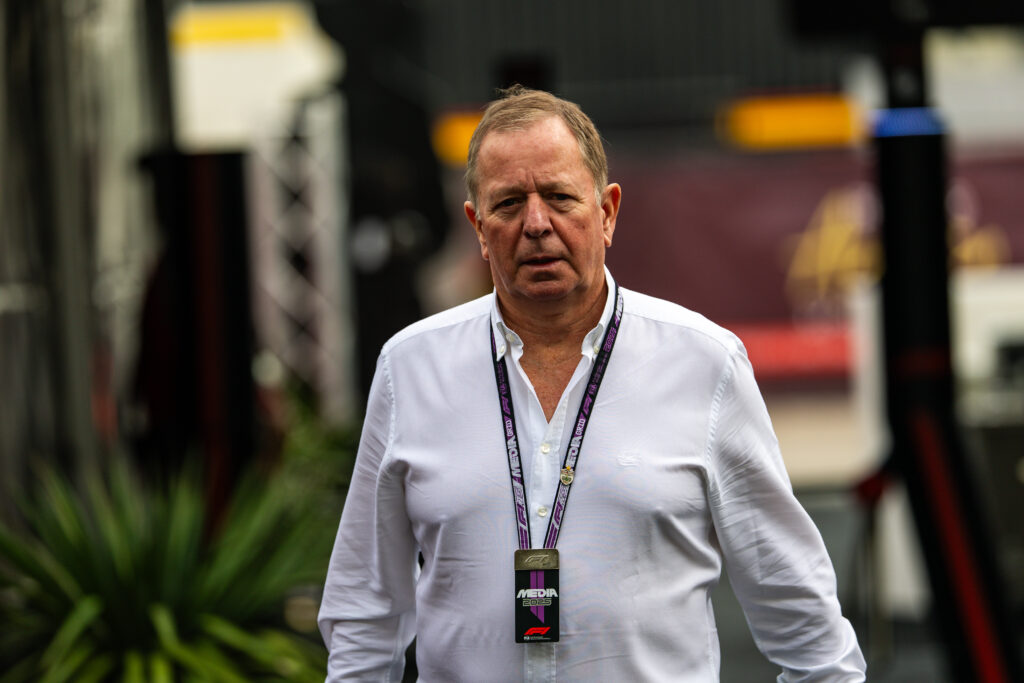 Martin Brundle walks in the Formula 1 paddock