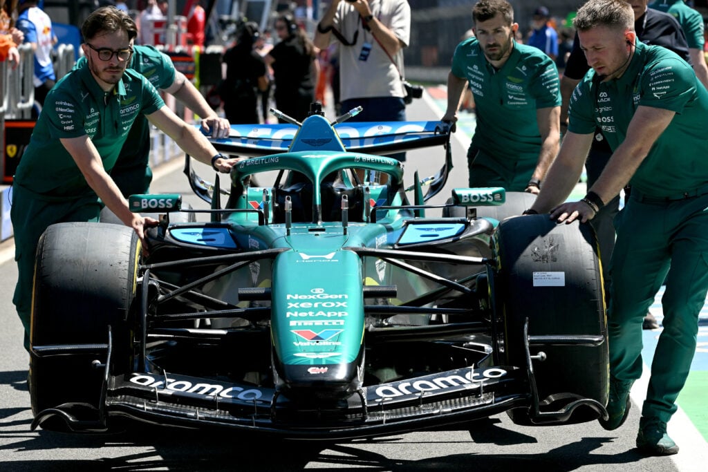 Mechanics take the car of Aston Martin's Canadian driver Lance Stroll for scrutineering ahead of the Formula One Australian Grand Prix at Melbourne's Albert Park on March 5, 2026.