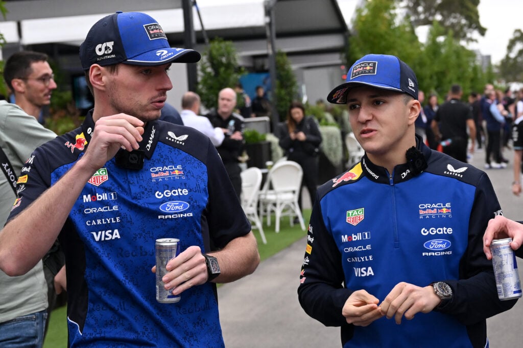 Red Bull Racing's Dutch driver Max Verstappen (L) and French driver Isack Hadjar walk through the paddock ahead of the first practice session of the Formula One Australian Grand Prix at the Albert Park Circuit in Melbourne on March 6, 2026.