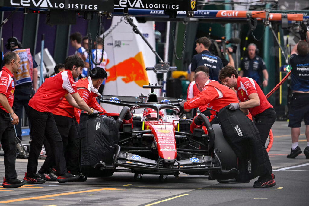 Mechanics work on the car of Ferrari's Monegasque driver Charles Leclerc in the pits during the qualifying session of the Formula One Australian Grand Prix at the Albert Park Circuit in Melbourne on March 7, 2026.