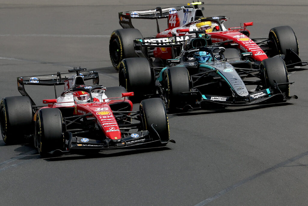 Ferrari's Charles Leclerc and Lewis Hamilton sandwiched around Mercedes' George Russell during the 2026 Australian Grand Prix.