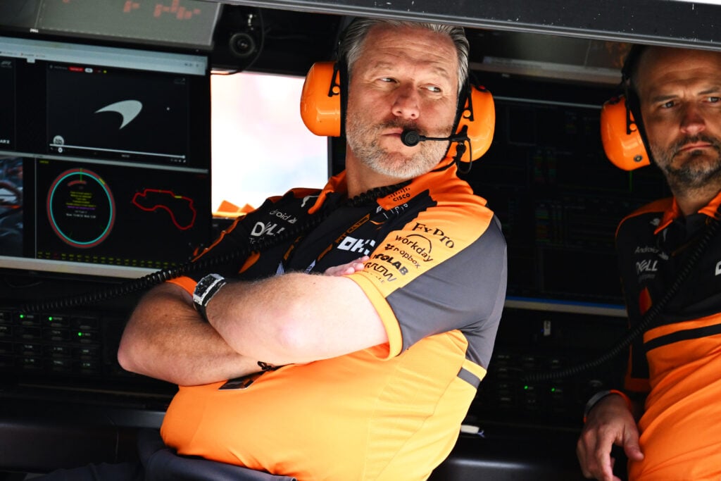 McLaren CEO Zak Brown sitting on the pit wall at the 2026 Australian Grand Prix