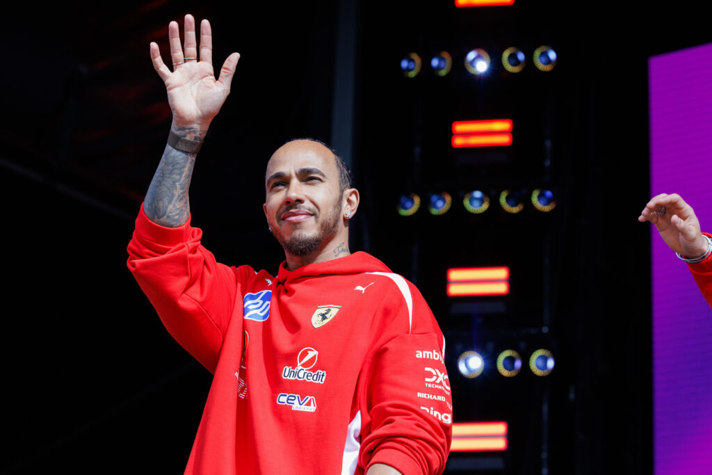 Lewis Hamilton of Ferrari waves at the F1 fan zone
