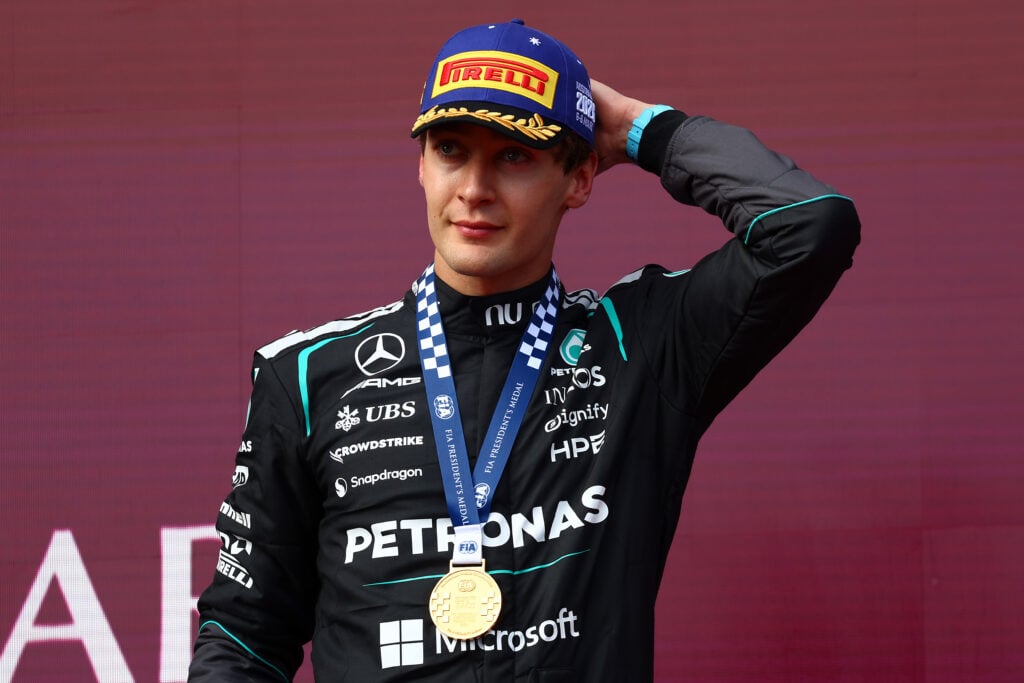Mercedes driver George Russell stands on the podium after winning the 2026 Australian Grand Prix