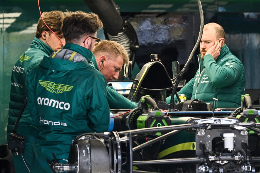 Aston Martin's Canadian driver Lance Stroll's team members work on the car in the garage at the Shanghai International Circuit ahead of the Formula One Chinese Grand Prix in Shanghai on March 12, 2026.