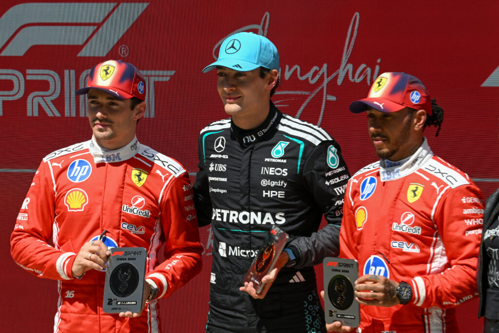 Mercedes' George Russell celebrates with Ferrari drivers Charles Leclerc and Lewis Hamilton after winning the F1 Sprint at the 2026 Chinese Grand Prix