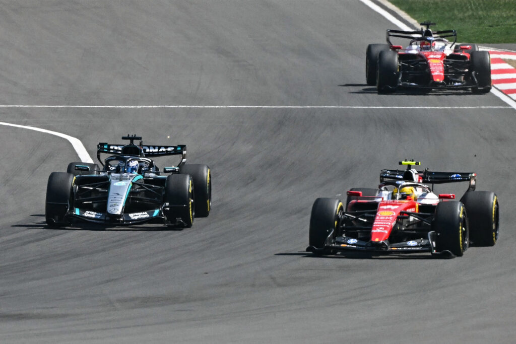 Mercedes' British driver George Russell (L), Ferrari's British driver Lewis Hamilton (R) and Ferrari's Monegasque driver Charles Leclerc (back) compete during the sprint race ahead of the Formula One Chinese Grand Prix at the Shanghai International Circuit in Shanghai on March 14, 2026.