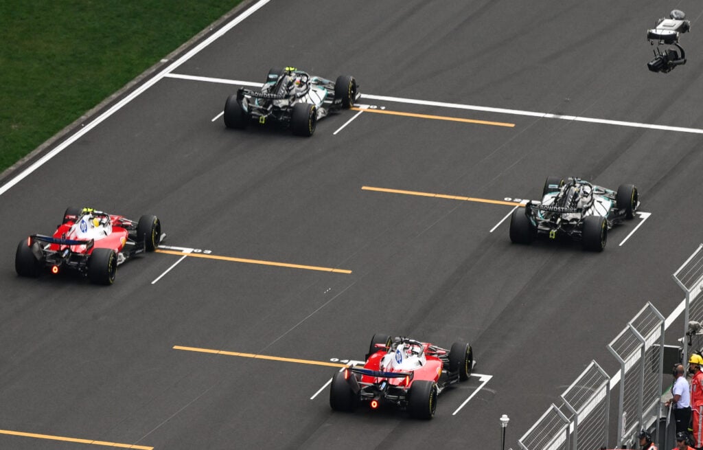 Mercedes' Andrea Kimi Antonelli and George Russell line up ahead of Ferrari's Lewis Hamilton and Charles Leclerc on the grid before the 2026 F1 Chinese Grand Prix