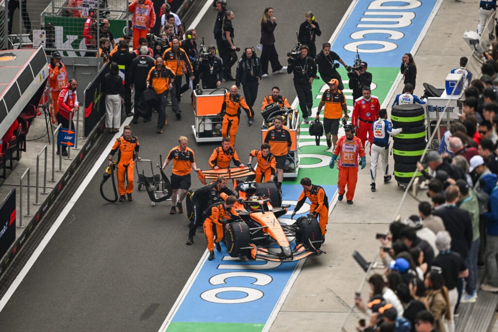 McLaren driver Oscar Piastri's car being wheeled back to the garage before the 2026 Chinese Grand Prix
